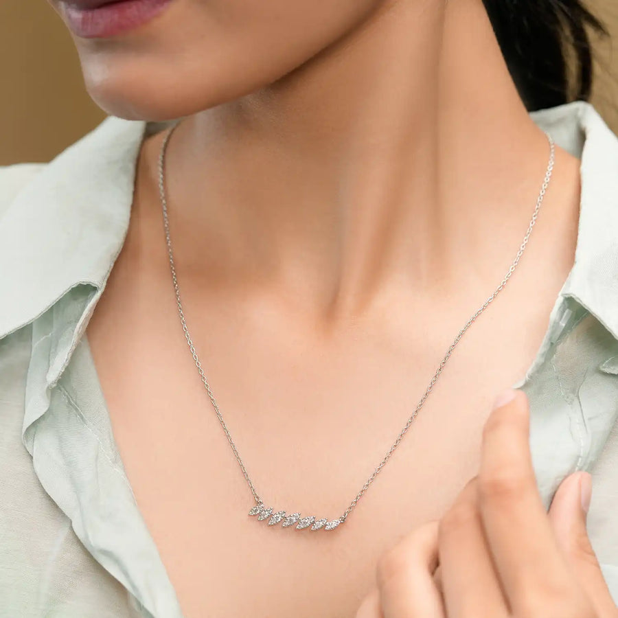 Model wearing cascading leaf diamond pendant