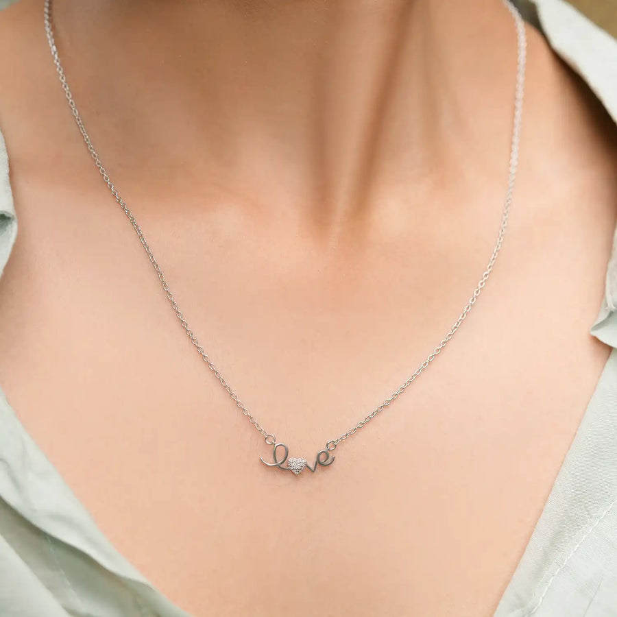 Model wearing love inscription diamond pendant