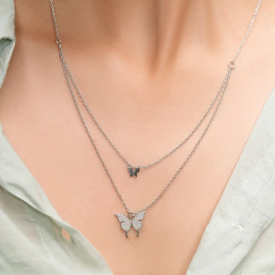 Model wearing double butterfly diamond pendant