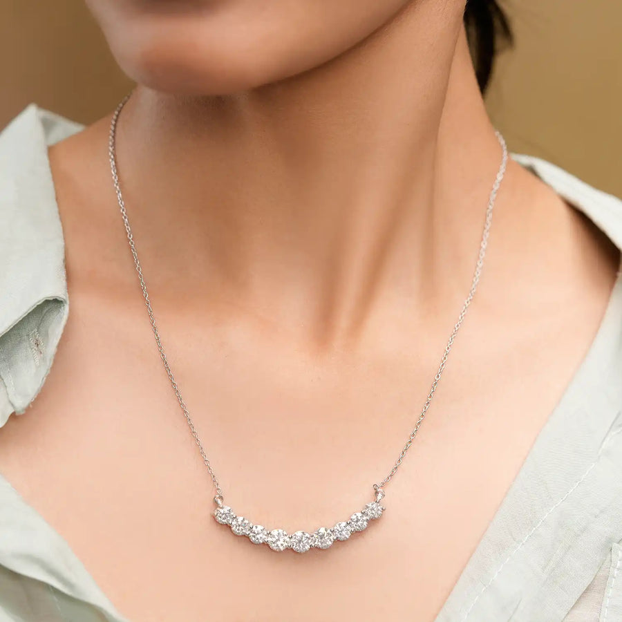 Model wearing circular arc gemstone pendant
