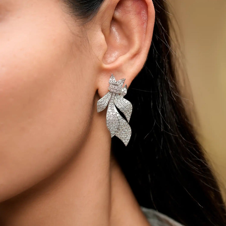 Model wearing leaf pavé statement earrings