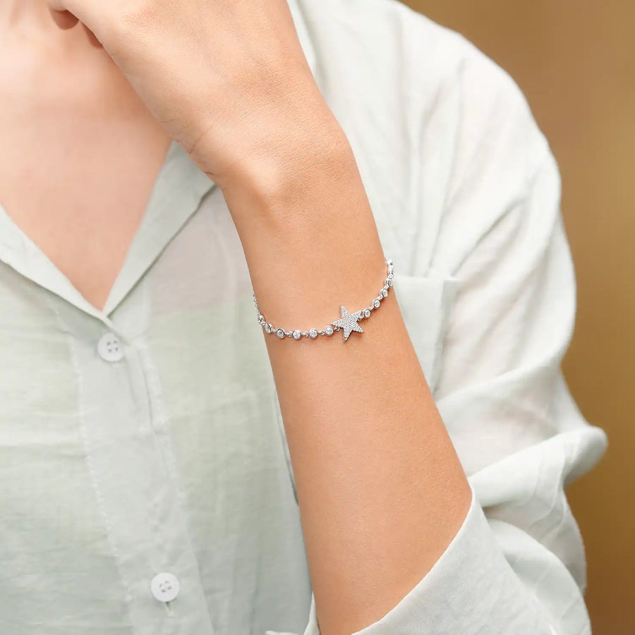 Wrist close-up highlighting star charm