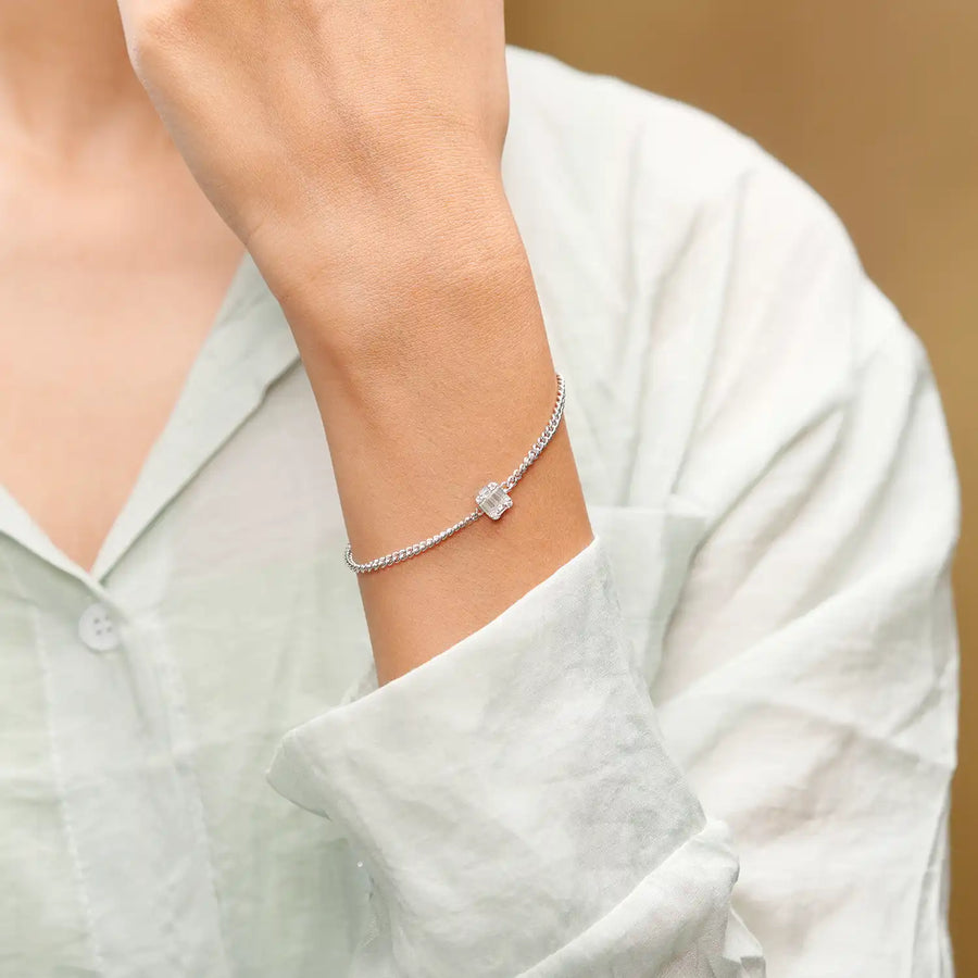 Model wearing square baguette gemstone bracelet