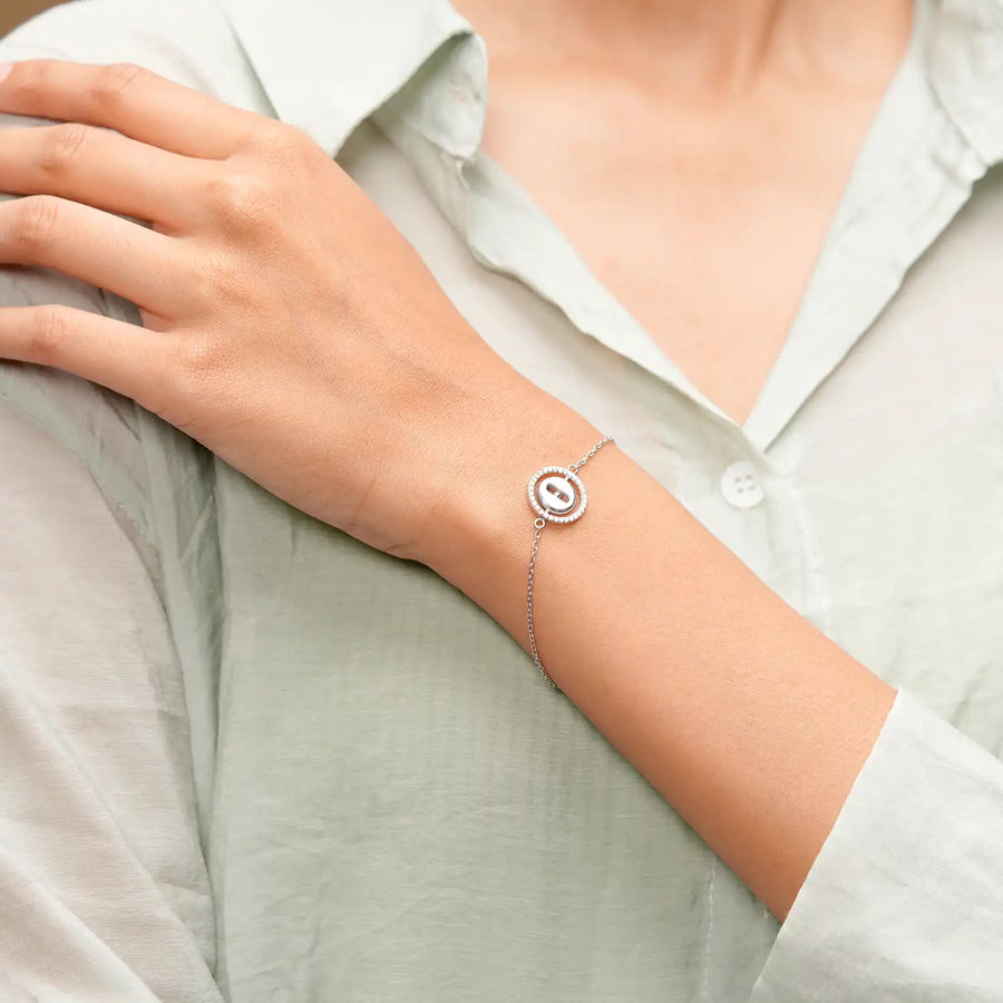 Wrist close-up showing circular charm