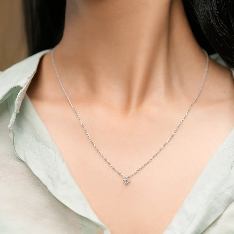 Model wearing four-diamond floral pendant