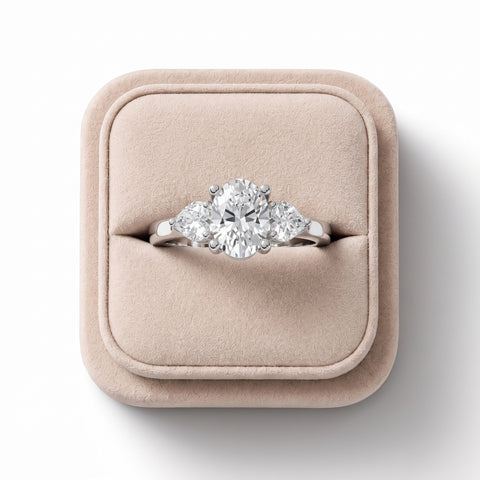 1.50 Ct oval three-stone lab diamond ring in 18K white gold, featuring a central oval diamond and two heart-shaped side stones.