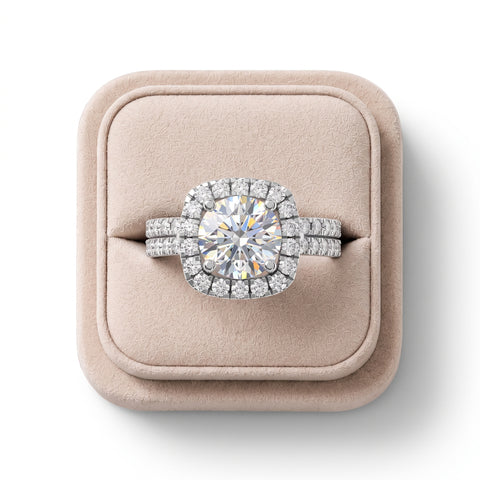 Round halo accent ring featuring a 1.50 CT center diamond, set on a split shank with pavé accents, presented on a cushioned display.