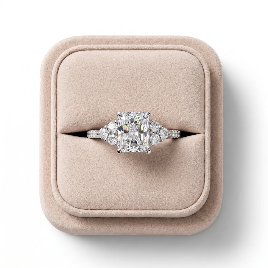 Radiant 1.5 CT lab grown diamond center ring in 18K gold, featuring round diamond halo and accent stones on the shoulders.