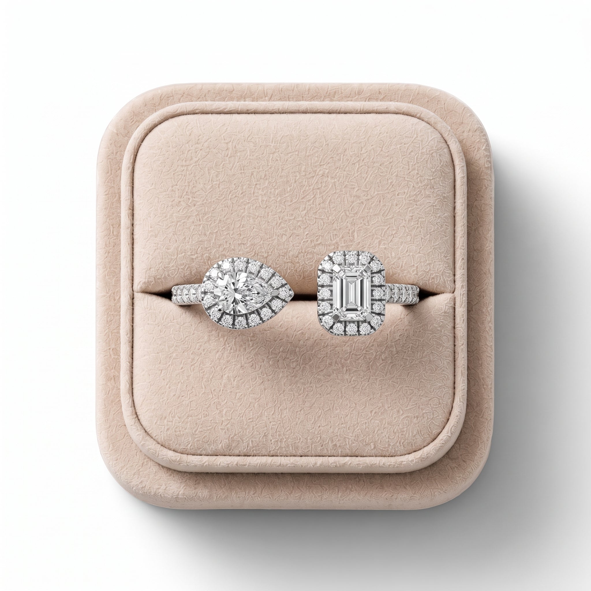 0.6 Ct two stone halo lab diamond ring features a pear-shaped and emerald-cut diamond in 18K gold with halo accents.