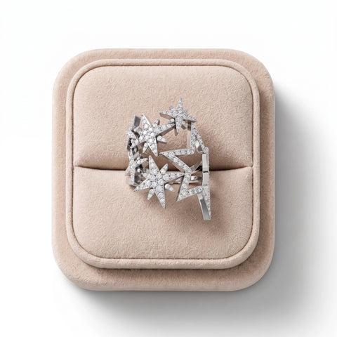Star-shaped lab diamond ring in 18K gold, featuring a zigzag openwork design with round diamonds. Set on a soft display.