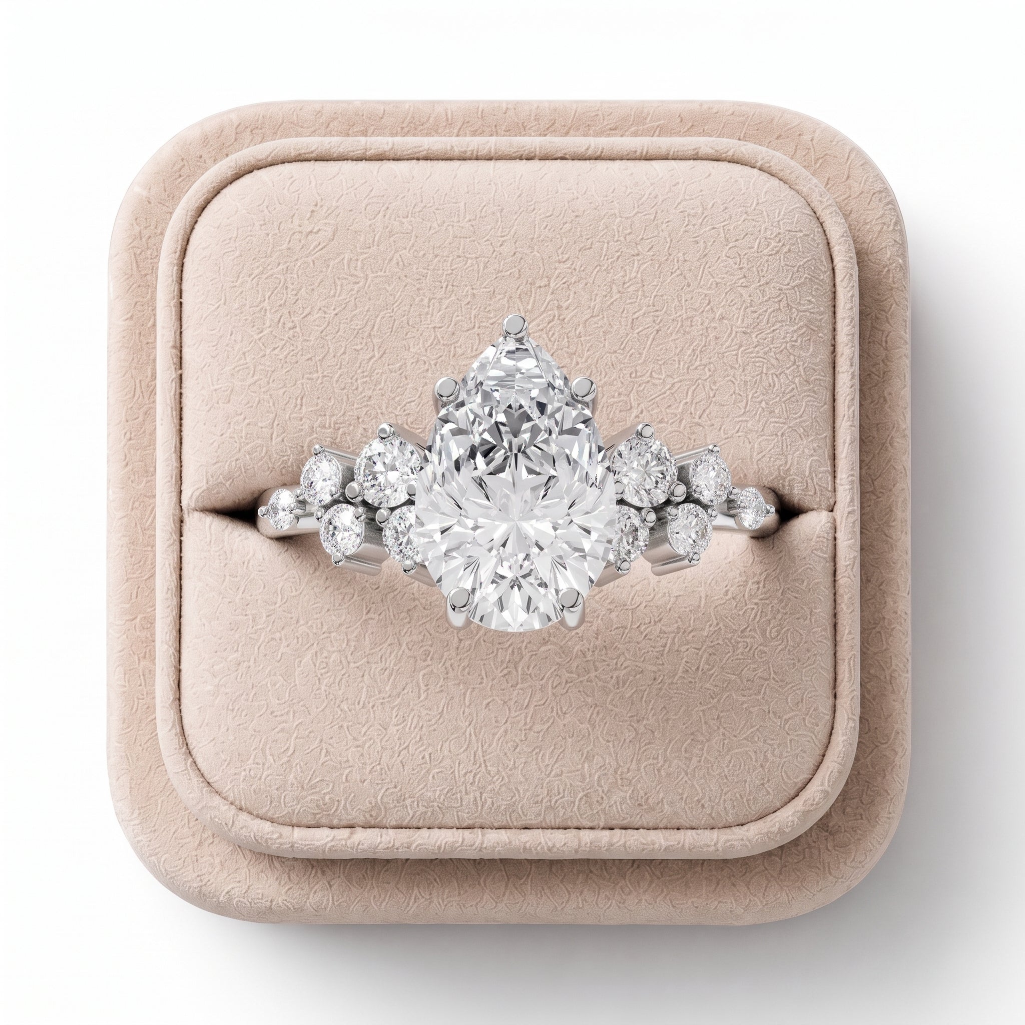 1.70 CT pear-shaped lab diamond ring featuring round side accents, elegantly displayed on a soft-colored jewelry box.