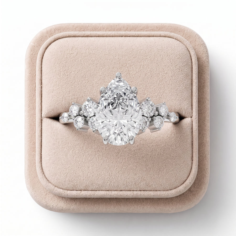 1.70 CT pear-shaped lab diamond ring featuring round side accents, elegantly displayed on a soft-colored jewelry box.