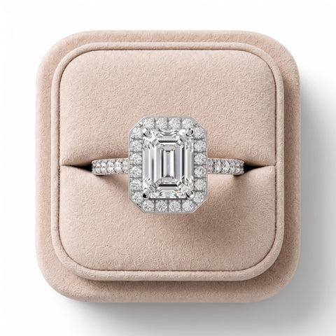 2.34 CT emerald cut lab diamond ring with a pavé band, featuring a halo of round diamonds and a polished silver setting.