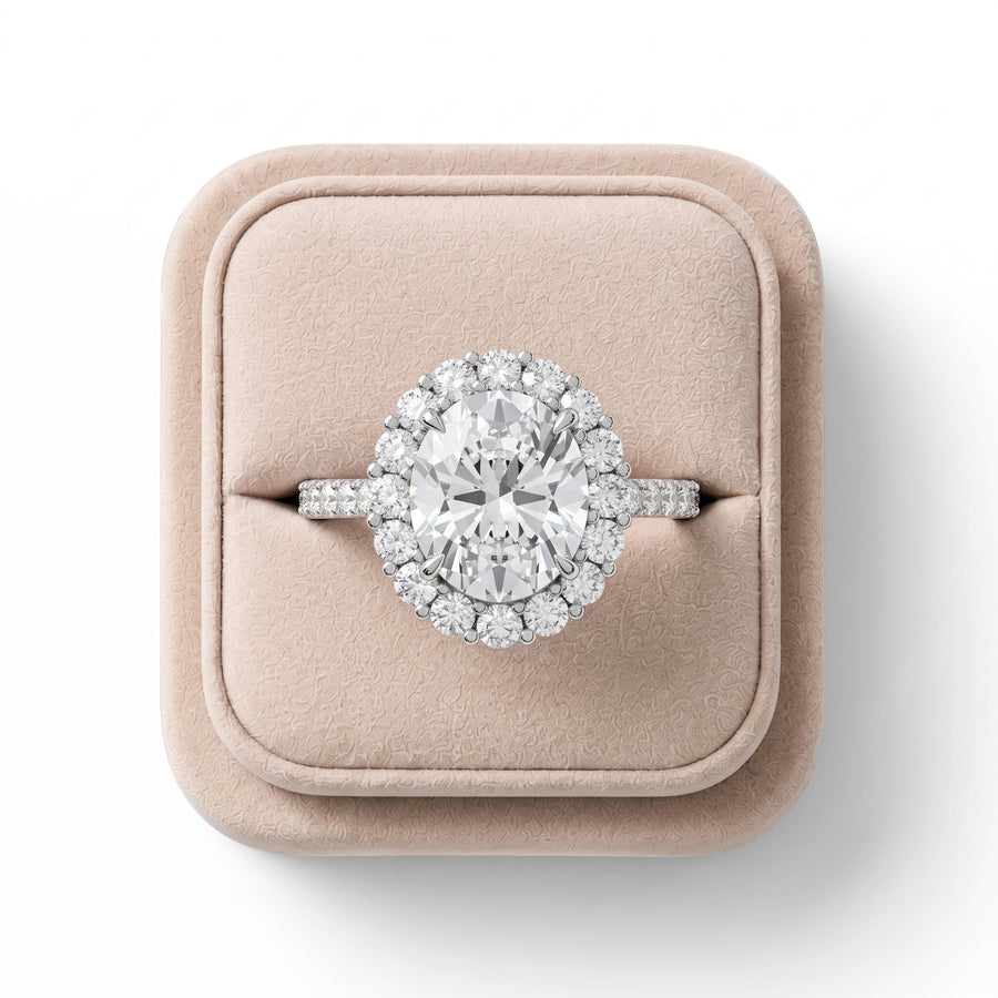 3.28 CT oval halo lab-grown diamond ring with a pavé band, featuring an elevated prong setting and round diamonds in a halo arrangement.