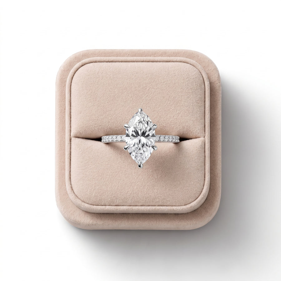 Lab grown diamond ring featuring a 2.5 CT marquise center stone in a six-prong setting; smooth band with hidden halo accents.