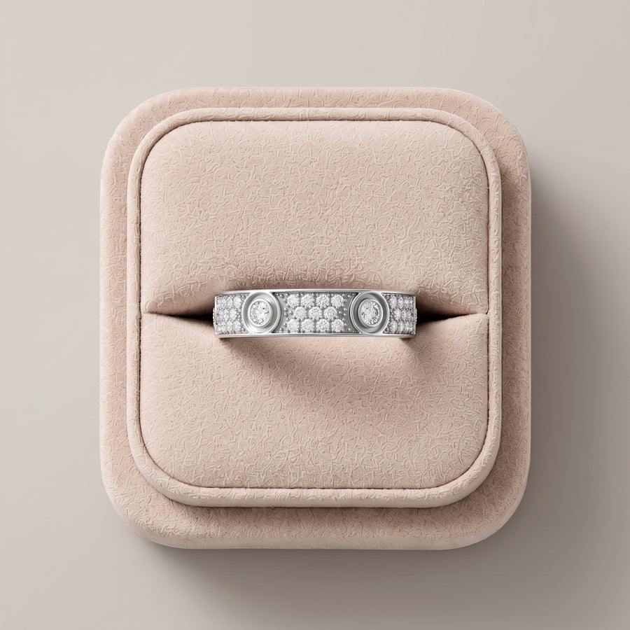 Wide 18K gold band featuring round lab grown diamonds in bezel and pavé settings, presented against a soft pink display.