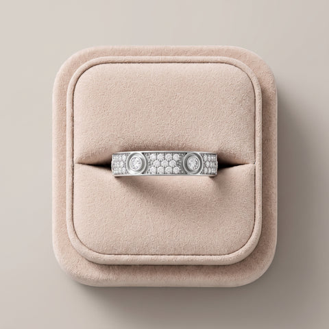 Wide 18K gold band featuring round lab grown diamonds in bezel and pavé settings, presented against a soft pink display.