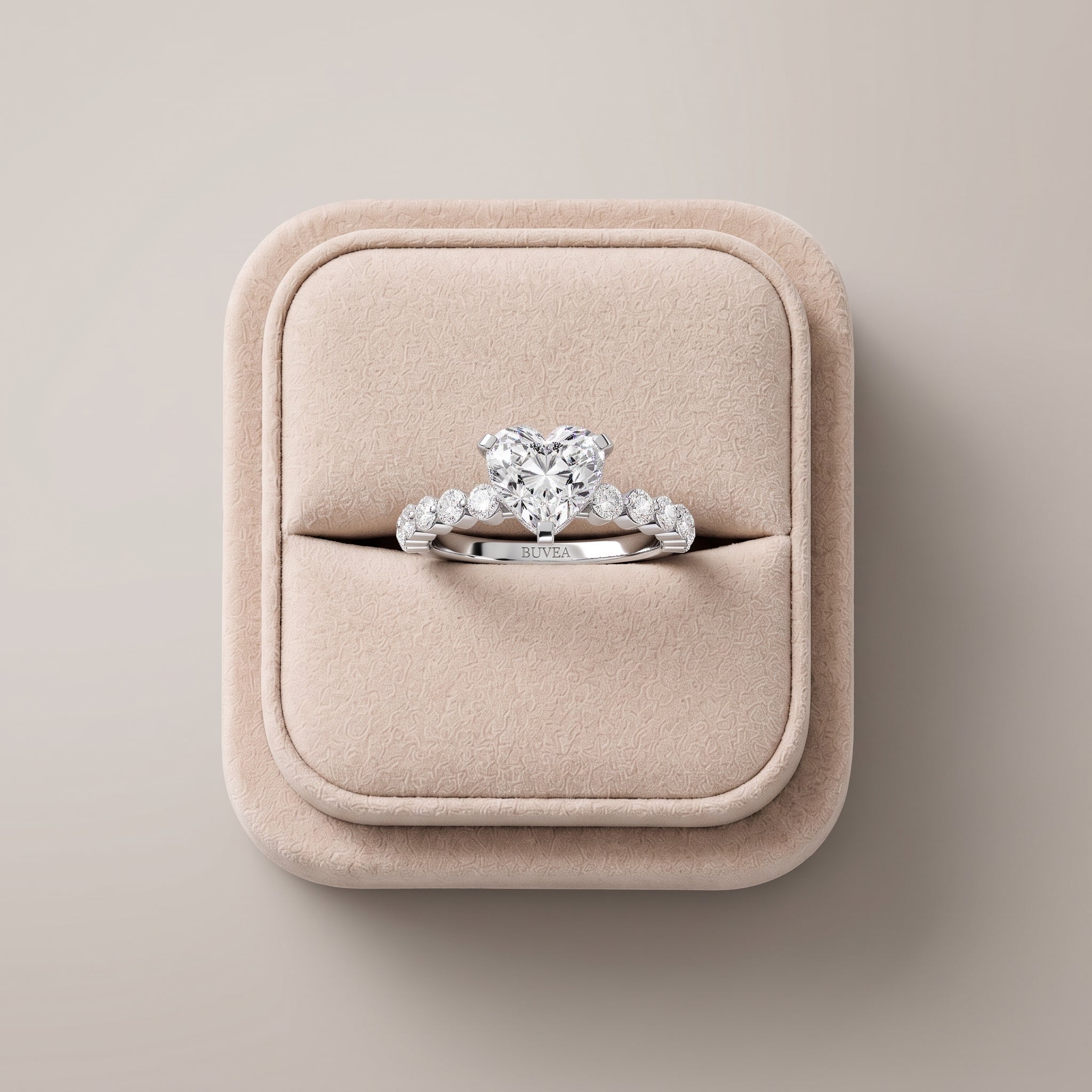 Heart-shaped lab diamond ring with a 2.77 ct total weight, set in an 18K gold band with round accent diamonds on each side.