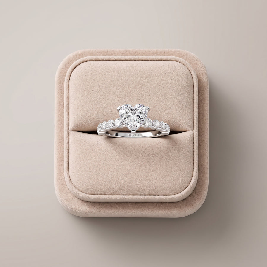 Heart-shaped lab diamond ring with a 2.77 ct total weight, set in an 18K gold band with round accent diamonds on each side.