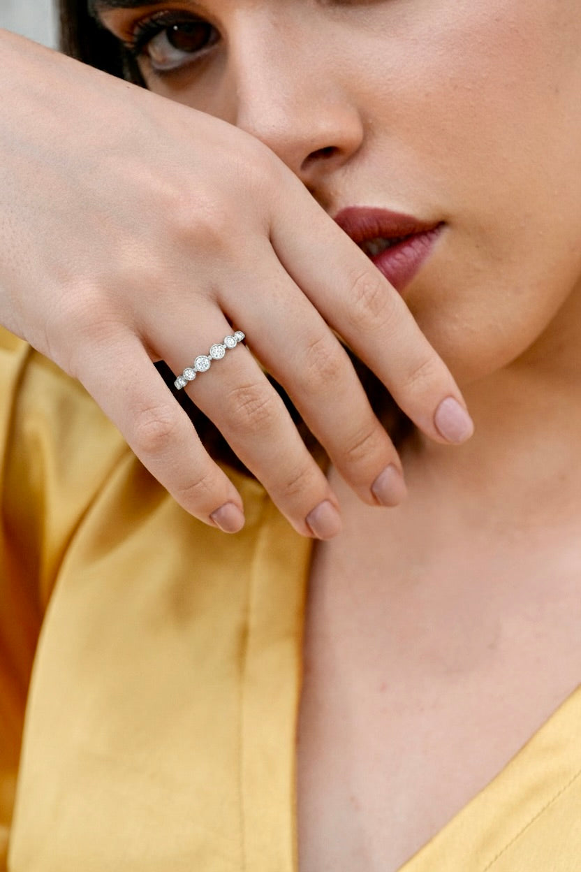 0.35 CT bezel set lab-grown diamond band worn on hand