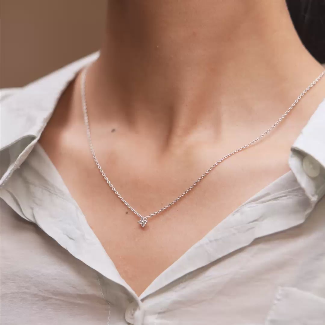 Pendant movement highlighting diamond brilliance on model