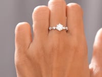 Model wearing round six-prong accented lab-grown diamond ring video