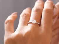 1.11 CT four-prong lab-grown diamond ring worn on hand