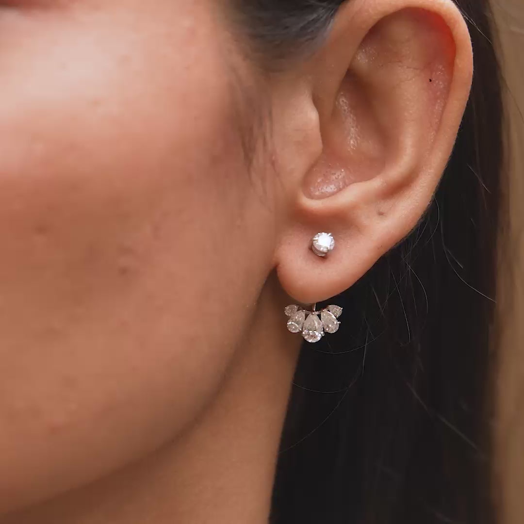 Earrings in motion demonstrating layered brilliance