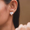 Earrings in motion demonstrating radial brilliance on model