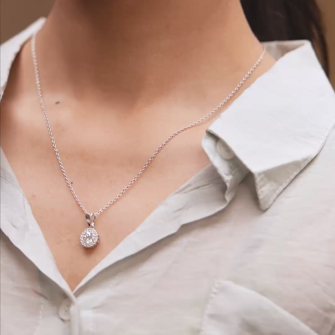 Model wearing 1.5 CT lab-grown diamond round halo pendant video clip
