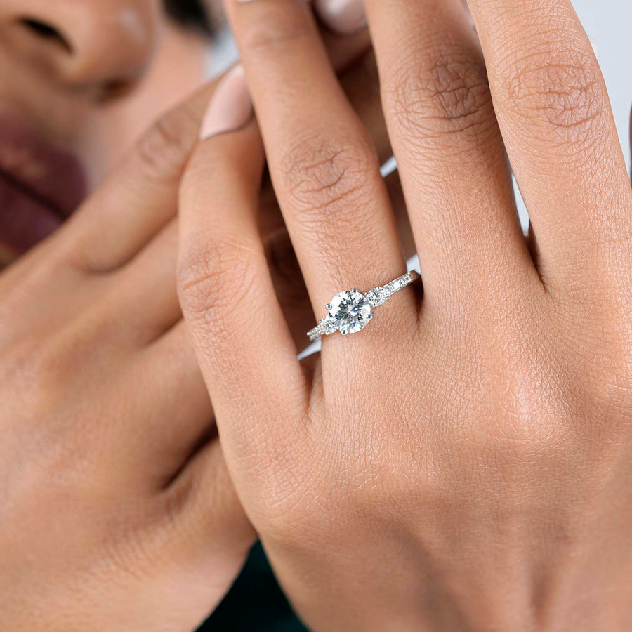 1.32 CT round lab-grown diamond three stone engagement ring worn on hand