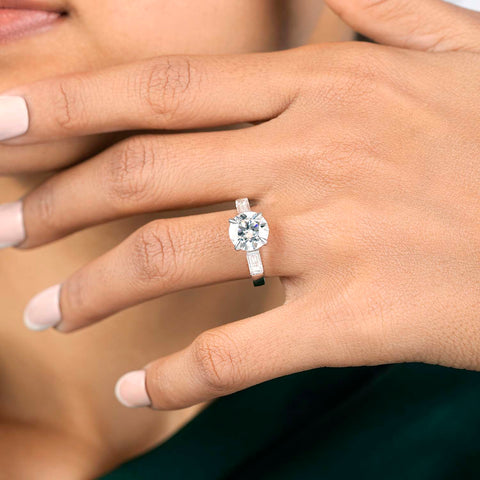 3.25 CT round lab-grown diamond three stone engagement ring worn on hand