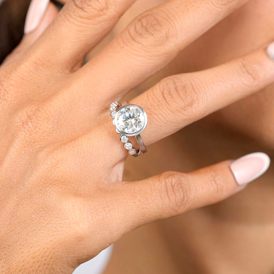 Lab-grown round bridal set hand close-up