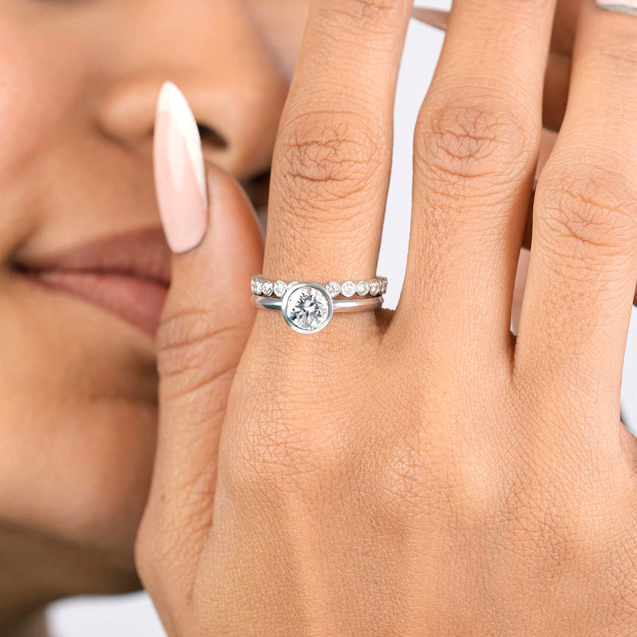 Lab-grown round bezel ring hand close-up