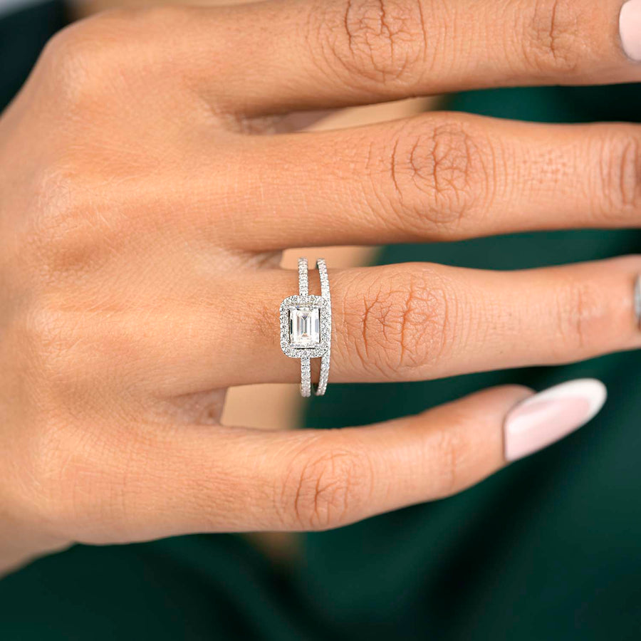 Lab-grown emerald halo ring hand close-up