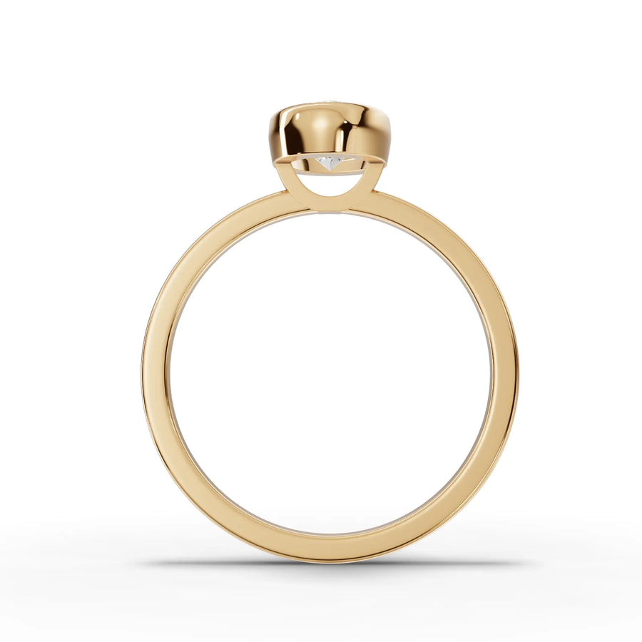 Lab-grown oval bezel ring yellow gold close-up