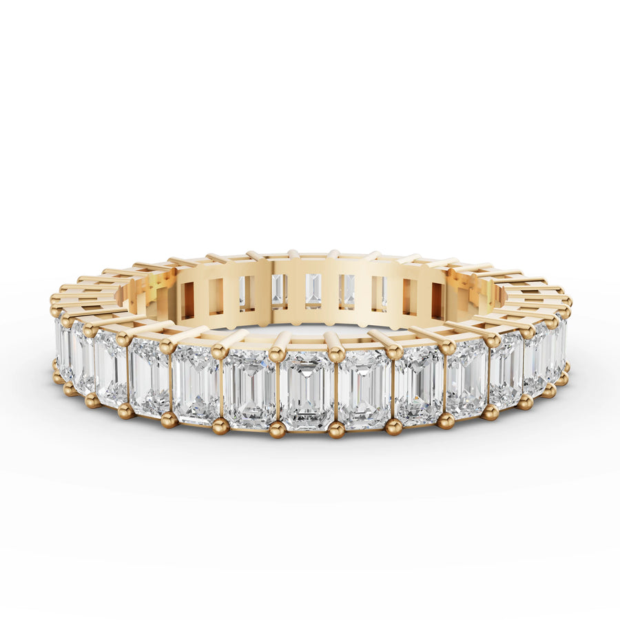 Emerald eternity band yellow gold angle